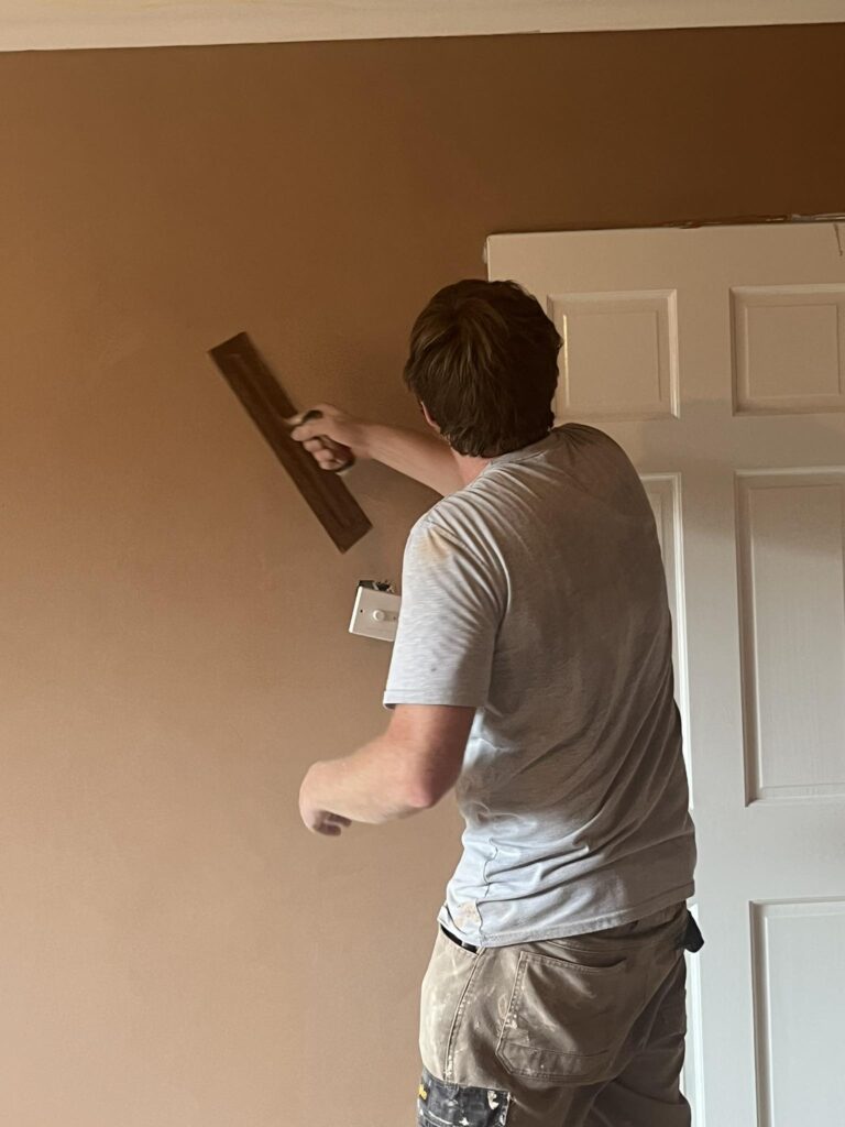 Tom plastering a wall in Warboys